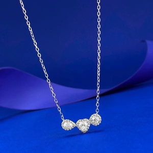 Detail of silver S925 necklace with teardrop, heart and round moissanite pendant