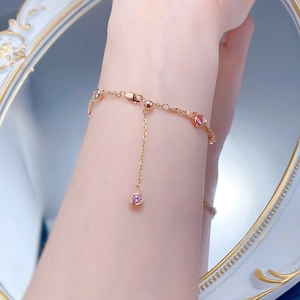 Detail of rose gold double-layer bubble bracelet with pink and white crystals on wrist