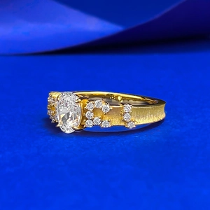 Brushed S925 gilded gold ring with an oval gemstone and pavé diamonds, 45-degree view