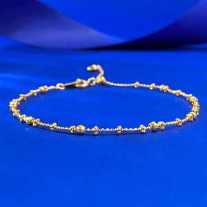 Detailed macro view of S925 silver gold-plated star bracelet with faceted beads and clasp