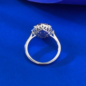 Detailed macro view of the intricate floral hollow pattern under the purple gemstone ring