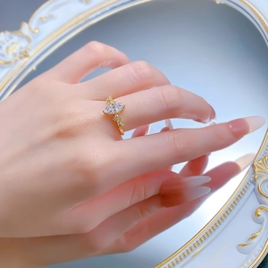 Close-up of a marquise-cut marquise diamond ring on hand with elegant gold plating