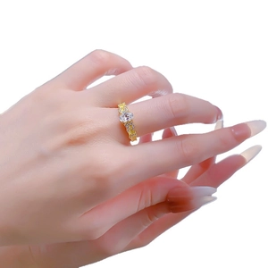 Elegant gold S925 silver ring featuring an oval crystal center stone worn by a model