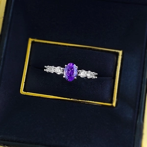 Elegant S925 silver ring featuring an oval purple gemstone and side zircons in a box