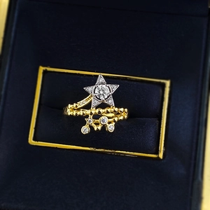 S925 silver double spiral star ring with gold finish and dangling charms in a box
