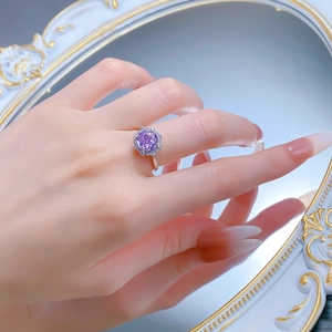 Detail of S925 silver ring featuring a round purple gemstone in a star-shaped setting