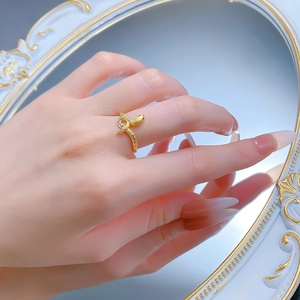 Detail of snake ring with red gem eye and white zircon pavé in vintage setting
