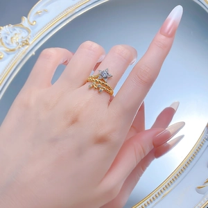 Detailed view of an S925 silver star ring with gold finish and sparkling zircon stones