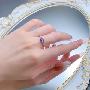 Close-up of S925 silver ring featuring an oval purple stone and side diamonds