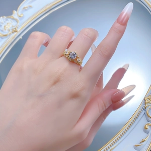 Close-up of vintage hollow-out gold ring with large round brilliant cut zircon