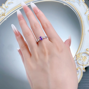 Detailed view of S925 silver ring featuring an oval purple gemstone and pavé accents
