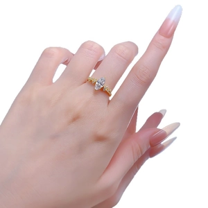 Elegant gold marquise cut solitaire ring with side accents on model's finger