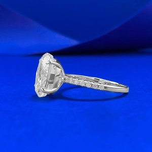 Elegant 4.5 carat oval ice-cut silver ring featuring a four-prong setting and side diamonds