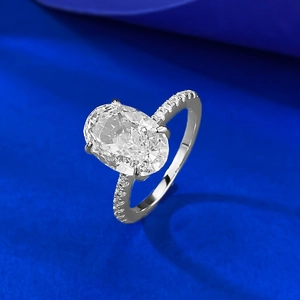Elegant 4.5 carat ice cut oval silver ring with pavé diamonds on blue background