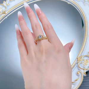 Macro view of a gold vintage style ring featuring a round zircon and hollow design detail