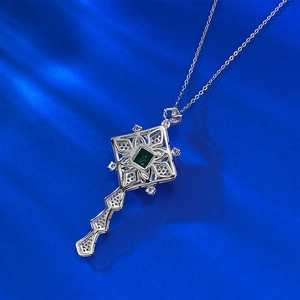Detailed macro view of S925 sterling silver key pendant with square green gemstone inlay