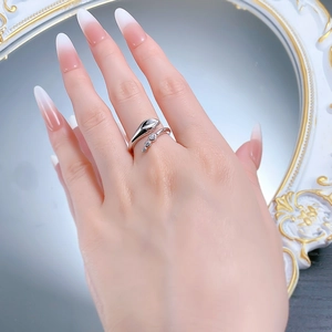 Detailed view of silver open snake ring with sparkling white zirconia stones on hand