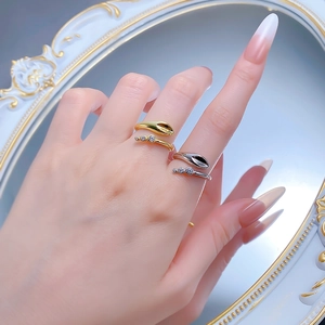 Detail of gold and silver snake rings with zircon stones in luxury vintage style