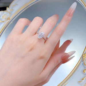 Detailed macro view of an oval-cut 4.5 carat ice-flower diamond ring on a finger