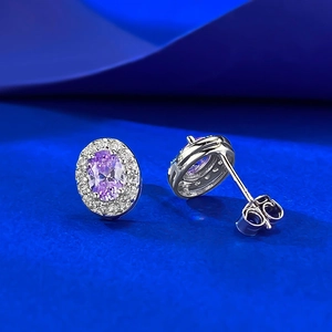 Macro shot of luxury oval purple zircon stud earrings with classic halo setting details