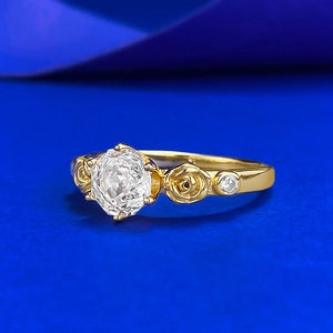 Luxury rose flower gold ring with a sparkling round zircon on a vibrant blue background