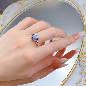 Macro detail of the 3-carat heart-shaped blue sapphire ring set in S925 silver on hand
