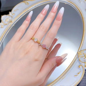 Detail of rose gold and white gold rings with round diamonds and floral settings