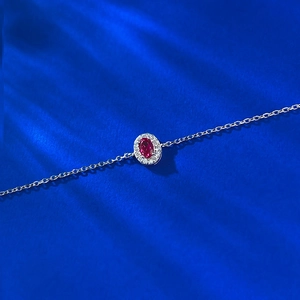 Elegant S925 sterling silver bracelet featuring an oval red ruby-tone gemstone centerpiece