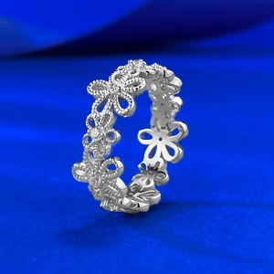 S925 sterling silver lace flower ring with cubic zirconia on a bright blue background