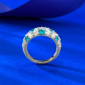 Detail of S925 silver ring with alternating green and white pavé cubic zirconia