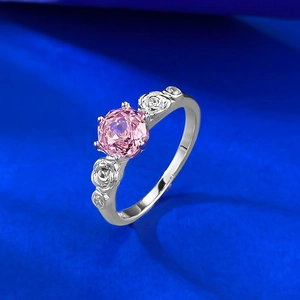 Elegant rose gold ring with a pink round gemstone and detailed floral carvings