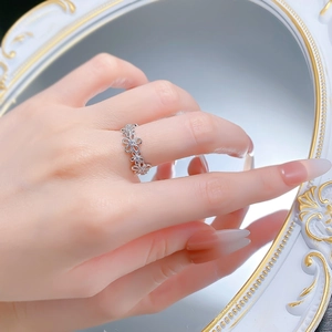 Detailed view of an S925 sterling silver lace floral ring with zircon accents on a hand