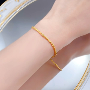 Detail of S925 sterling silver gold-plated bamboo joint bracelet on woman's wrist
