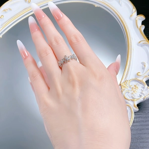 Macro detail of S925 silver lace flower ring with zircon pave stones on a mirror