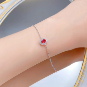 Close-up of S925 silver bracelet with oval red stone and small diamonds on wrist