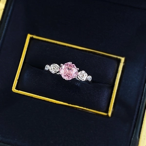 Luxurious rose cut ring with pink sapphire and sculpted silver roses in a velvet box