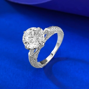 Macro view of silver ring featuring a 2.5 carat round stone and hollow pavé side detailing