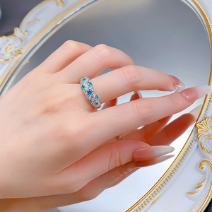 Macro detail of S925 silver ring featuring gradient blue and white pavé-set gemstones