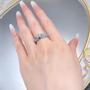 Detail of S925 silver ring featuring half-band blue-green and white gemstone pavé setting