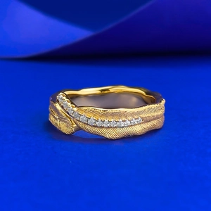 Macro detail of gold vintage leaf ring featuring fine Italian brushed texture and diamonds