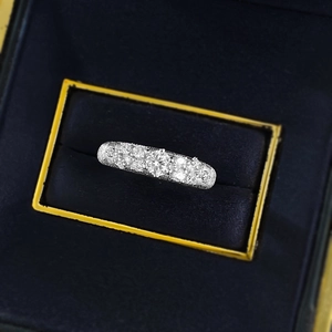 Macro shot of silver textured star ring with sparkling diamonds in a jewelry box