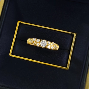 Close-up of a brushed gold plated S925 silver ring with sparkling star-set stones in a box