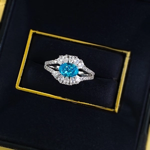 Luxurious S925 silver ring featuring a large oval blue gemstone in a halo diamond setting