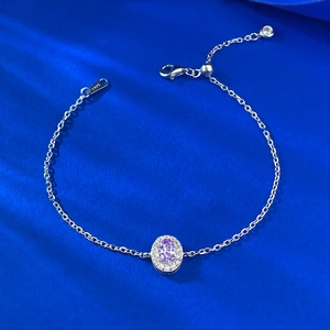 Elegant S925 sterling silver bracelet with oval purple gemstone on blue silk background