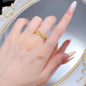 Macro detail of leaf ring showing brushed gold finish and sparkling diamond inlay