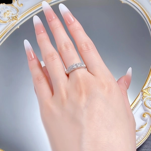 Close-up of S925 silver pavé eternity ring worn by a person against a vintage mirror