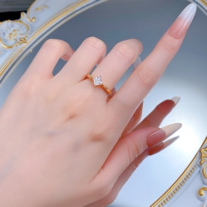 Close-up of a 5x5mm princess cut diamond ring in gold finish on a model hand