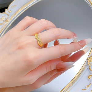 Detailed view of leaf ring with brushed gold texture and pavé set diamonds on model