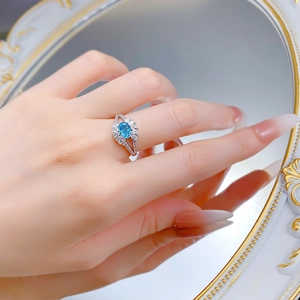 Macro shot of S925 silver ring featuring an oval blue aquamarine and floral zircons