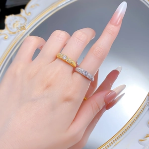 Close-up of gold and silver S925 rings with sparkling star-like pave-set diamonds